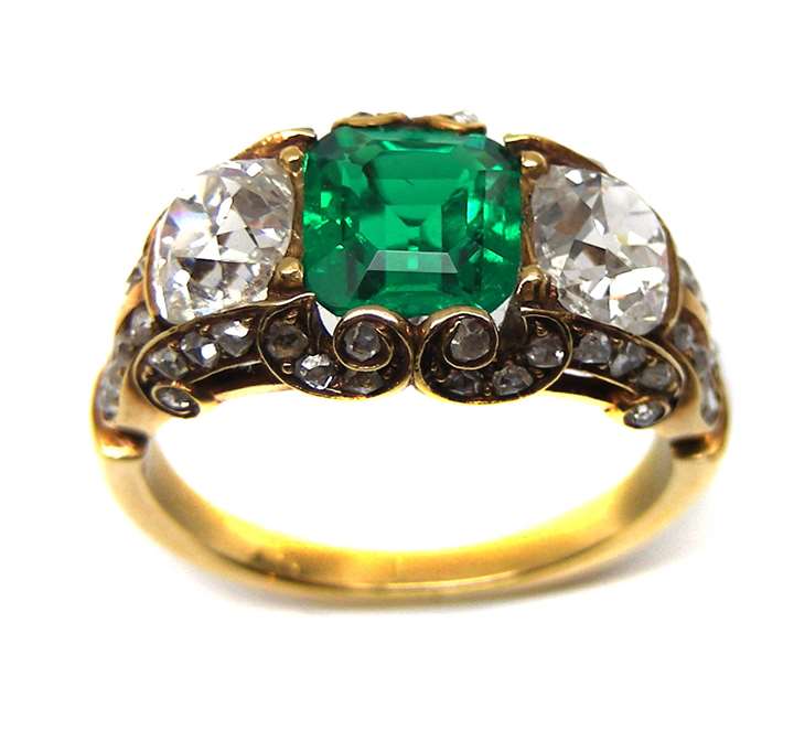 Antique emerald and diamond three stone half hoop ring